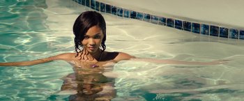 Movie still from “Dope” (2015), directed by Rick Famuyiwa – A woman in a swimming pool posing for a picture; Medium shot, High angle