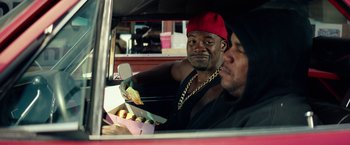 Movie still from “Dope” (2015), directed by Rick Famuyiwa – Two men in a car eating hot dogs; Medium shot, Over the shoulder angle