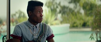 Movie still from “Dope” (2015), directed by Rick Famuyiwa – A young man with a guitar looking to his left; Close Up shot, Over the shoulder angle