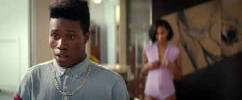 Movie still from “Dope” (2015), directed by Rick Famuyiwa – A man in a blue shirt and a woman in a purple dress; Close Up shot, Over the shoulder angle