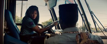 Movie still from “Dope” (2015), directed by Rick Famuyiwa – A woman sitting in the driver's seat of a vehicle; Medium shot, Over the shoulder angle