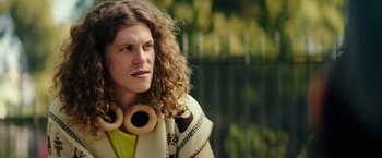 Movie still from “Dope” (2015), directed by Rick Famuyiwa – A man with long curly hair wearing headphones; Close Up shot, Over the shoulder angle