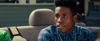 Movie still from “Dope” (2015), directed by Rick Famuyiwa – A young man sitting in the back seat of a car; Close Up shot, Over the shoulder angle