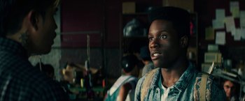 Movie still from “Dope” (2015), directed by Rick Famuyiwa – A young man is looking into the distance; Close Up shot, Over the shoulder angle