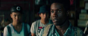 Movie still from “Dope” (2015), directed by Rick Famuyiwa – A young man with a backpack and hat; Close Up shot, Over the shoulder angle