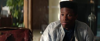 Movie still from “Dope” (2015), directed by Rick Famuyiwa – A young man with a black afro sits in front of a mirror; Close Up shot, Over the shoulder angle