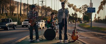 Movie still from “Dope” (2015), directed by Rick Famuyiwa – A group of young men playing instruments on the side of the road; Wide shot, Low angle