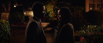 Movie still from “Dope” (2015), directed by Rick Famuyiwa – A man and a woman standing next to each other in the dark; Medium shot, Low angle