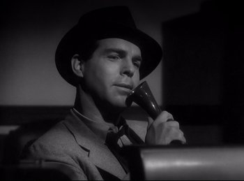 Movie still from “Double Indemnity” (1944), directed by Billy Wilder – A black and white photo of a man in a suit and tie holding a phone; Close Up shot, Low angle
