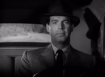 Movie still from “Double Indemnity” (1944), directed by Billy Wilder – A black and white photo of a man in a suit and hat; Close Up shot, Low angle