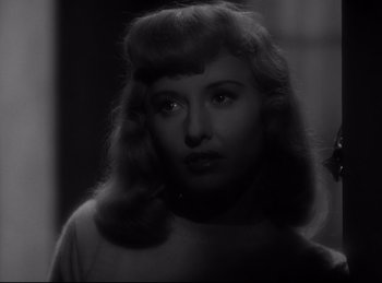 Movie still from “Double Indemnity” (1944), directed by Billy Wilder – A black and white photo of a woman in a white shirt; Close Up shot, Over the shoulder angle