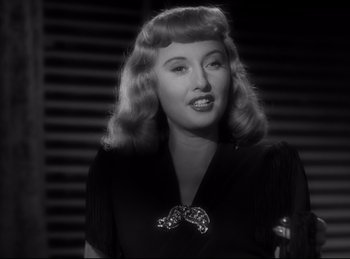 Movie still from “Double Indemnity” (1944), directed by Billy Wilder – A black and white photo of a woman with blonde hair; Close Up shot, Low angle