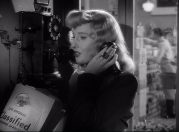 Movie still from “Double Indemnity” (1944), directed by Billy Wilder – A black and white photo of a woman talking on a phone; Close Up shot, High angle