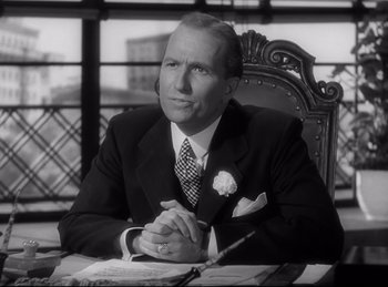 Movie still from “Double Indemnity” (1944), directed by Billy Wilder – An older man in a suit sitting at a table; Close Up shot, Low angle