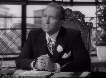 Movie still from “Double Indemnity” (1944), directed by Billy Wilder – A man sitting at a table in front of a window; Close Up shot, Low angle
