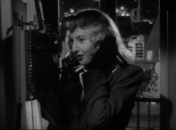 Movie still from “Double Indemnity” (1944), directed by Billy Wilder – A black and white photo of a woman talking on a phone; Close Up shot, Low angle
