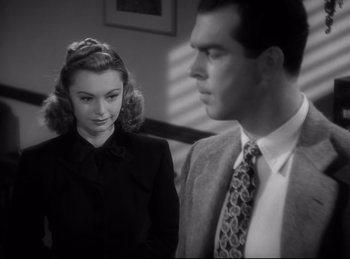 Movie still from “Double Indemnity” (1944), directed by Billy Wilder – A man and a woman standing next to each other; Close Up shot, Over the shoulder angle