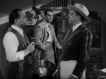 Movie still from “Double Indemnity” (1944), directed by Billy Wilder – A group of men standing next to each other in a room; Medium shot, Low angle