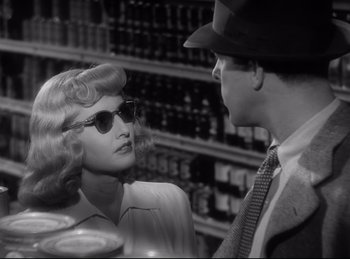 Movie still from “Double Indemnity” (1944), directed by Billy Wilder – A man and a woman are talking to each other in a store; Close Up shot, Over the shoulder angle