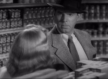 Movie still from “Double Indemnity” (1944), directed by Billy Wilder – A black and white photo of a man and a woman; Close Up shot, Over the shoulder angle