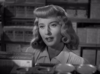 Movie still from “Double Indemnity” (1944), directed by Billy Wilder – A black and white photo of a woman in a grocery store; Close Up shot, Over the shoulder angle