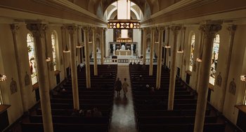 Movie still from “Doubt” (2008), directed by John Patrick Shanley – Two people are standing in a large church with pews; Extreme Wide shot, High angle