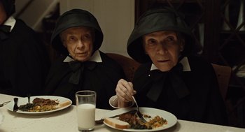 Movie still from “Doubt” (2008), directed by John Patrick Shanley – A couple of women sitting at a table with food; Medium shot, High angle
