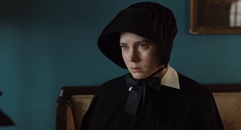 Movie still from “Doubt” (2008), directed by John Patrick Shanley – A woman in a black dress and a black hat; Close Up shot, Over the shoulder angle