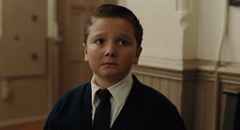 Movie still from “Doubt” (2008), directed by John Patrick Shanley – A young boy wearing a suit and a tie; Close Up shot, High angle
