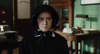 Movie still from “Doubt” (2008), directed by John Patrick Shanley – A woman wearing a black cape and a black hat; Close Up shot, Over the shoulder angle