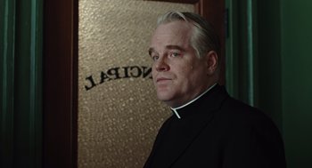 Movie still from “Doubt” (2008), directed by John Patrick Shanley – A man in a priest's outfit standing in front of a mirror; Close Up shot, Low angle