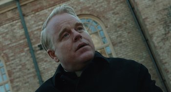 Movie still from “Doubt” (2008), directed by John Patrick Shanley – A man that is wearing a black jacket; Close Up shot, Low angle