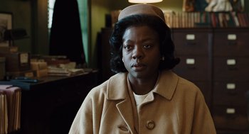Movie still from “Doubt” (2008), directed by John Patrick Shanley – A woman in a tan coat and a hat; Close Up shot, Over the shoulder angle