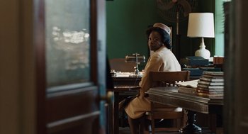Movie still from “Doubt” (2008), directed by John Patrick Shanley – A person sitting at a table in front of a window; Medium shot, Over the shoulder angle