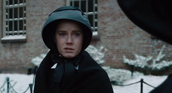 Movie still from “Doubt” (2008), directed by John Patrick Shanley – A woman wearing a black coat and a black hat; Close Up shot, Over the shoulder angle