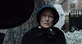 Movie still from “Doubt” (2008), directed by John Patrick Shanley – An older woman wearing a hat and glasses; Close Up shot, Over the shoulder angle