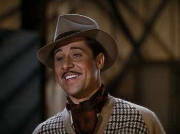 Movie still from “Down Argentine Way” (1940), directed by Irving Cummings – A man with a mustache wearing a hat and a sweater; Close Up shot, High angle