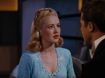 Movie still from “Down Argentine Way” (1940), directed by Irving Cummings – A woman with blonde hair and a blue dress; Close Up shot, Over the shoulder angle