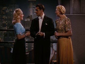 Movie still from “Down Argentine Way” (1940), directed by Irving Cummings – Two women and a man standing next to each other in front of a building; Medium shot, High angle