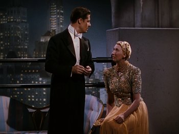 Movie still from “Down Argentine Way” (1940), directed by Irving Cummings – A man and a woman in formal wear standing next to each other; Medium shot, High angle