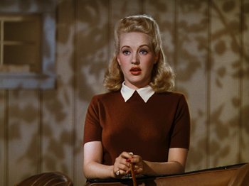 Movie still from “Down Argentine Way” (1940), directed by Irving Cummings – A woman with blonde hair wearing a brown sweater; Close Up shot, Low angle