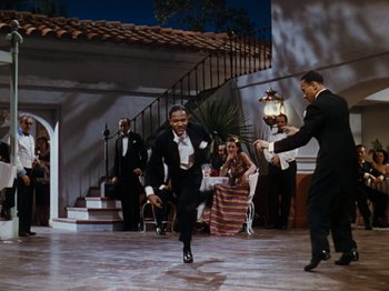 Movie still from “Down Argentine Way” (1940), directed by Irving Cummings – A group of men in suits and ties dancing in front of a group of people; Wide shot, High angle