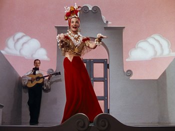 Movie still from “Down Argentine Way” (1940), directed by Irving Cummings – A man and a woman dressed in costume on a stage; Wide shot, Low angle