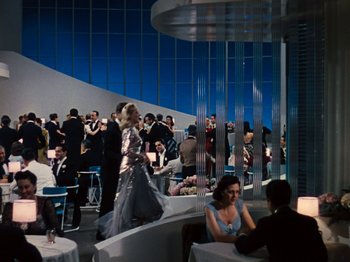 Movie still from “Down Argentine Way” (1940), directed by Irving Cummings – A group of people are gathered around a restaurant; Extreme Wide shot, Low angle