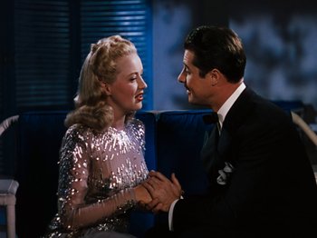 Movie still from “Down Argentine Way” (1940), directed by Irving Cummings – A man and a woman holding each others hands; Medium shot, High angle