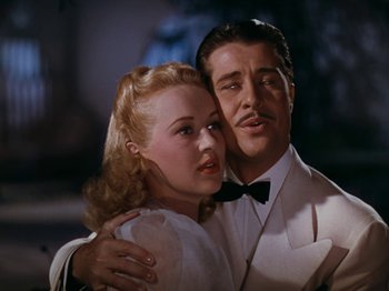 Movie still from “Down Argentine Way” (1940), directed by Irving Cummings – A man and a woman in white dress clothes; Close Up shot, Low angle