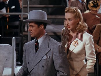 Movie still from “Down Argentine Way” (1940), directed by Irving Cummings – A man and a woman standing next to each other; Medium shot, High angle