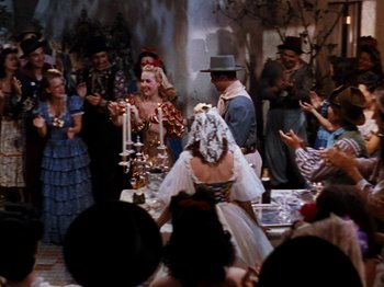 Movie still from “Down Argentine Way” (1940), directed by Irving Cummings – A group of people standing in a room; Wide shot, High angle