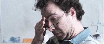 Movie still from “Down Terrace” (2009), directed by Ben Wheatley – A person with glasses on; Close Up shot, Low angle