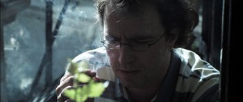 Movie still from “Down Terrace” (2009), directed by Ben Wheatley – A person smoking a cigarette; Extreme Close Up shot, Low angle